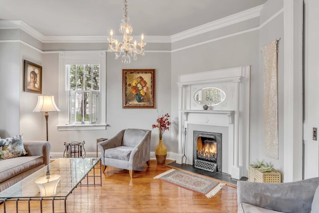 sitting room featuring hardwood / wood-style flooring, an inviting chandelier, and crown molding