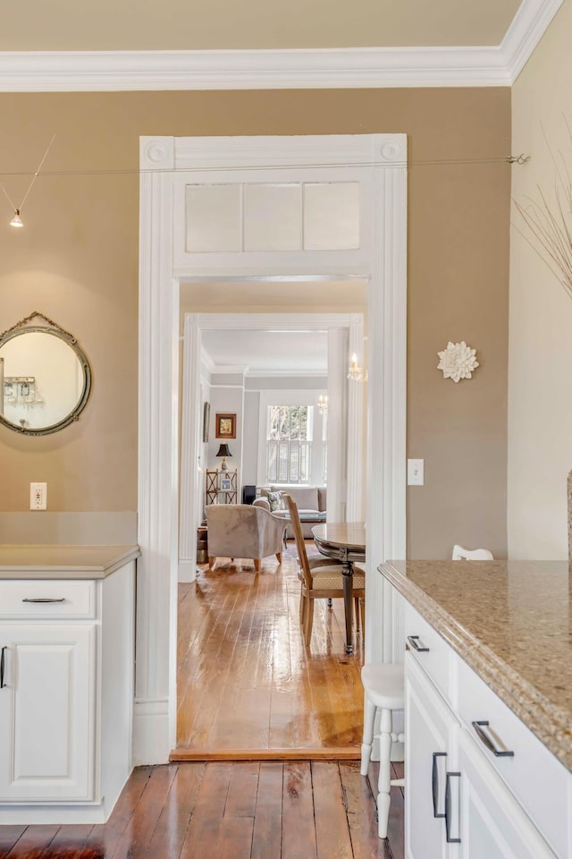 interior space with hardwood / wood-style floors and crown molding