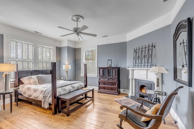 bedroom with ceiling fan and light hardwood / wood-style flooring