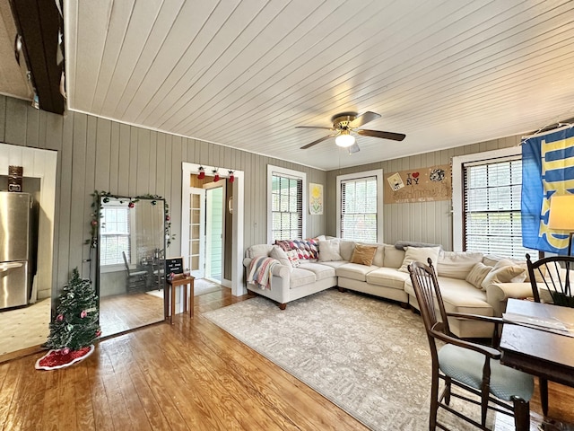 living room featuring hardwood / wood-style floors, a wealth of natural light, ceiling fan, and wood ceiling