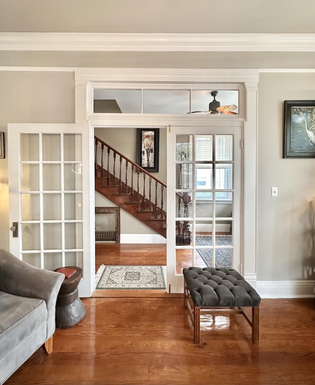 entryway with crown molding and hardwood / wood-style floors