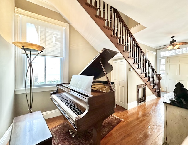 misc room with hardwood / wood-style flooring, ceiling fan, and crown molding