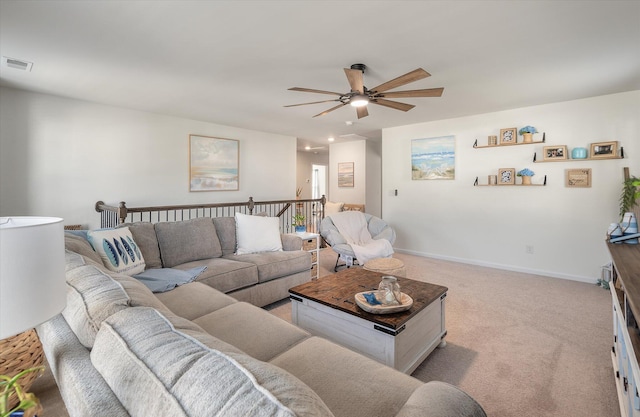 living room with light colored carpet and ceiling fan