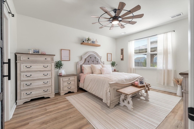 bedroom with ceiling fan and light hardwood / wood-style flooring