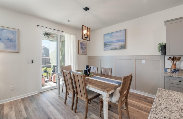 dining room with an inviting chandelier and light hardwood / wood-style flooring