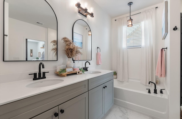 bathroom featuring tub / shower combination and vanity