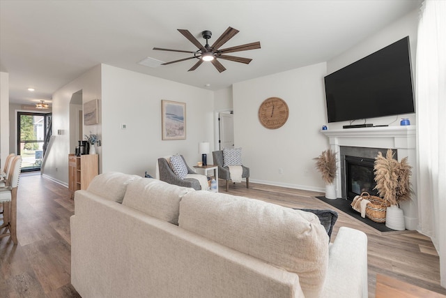 living room featuring ceiling fan and wood-type flooring