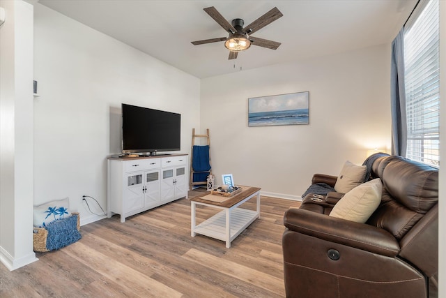 living room featuring light hardwood / wood-style flooring and ceiling fan