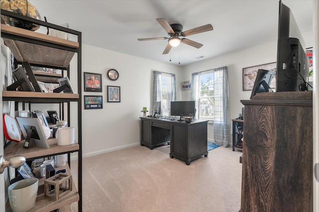 carpeted office featuring ceiling fan