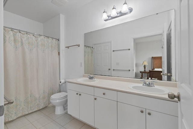 bathroom with tile patterned floors, vanity, and toilet