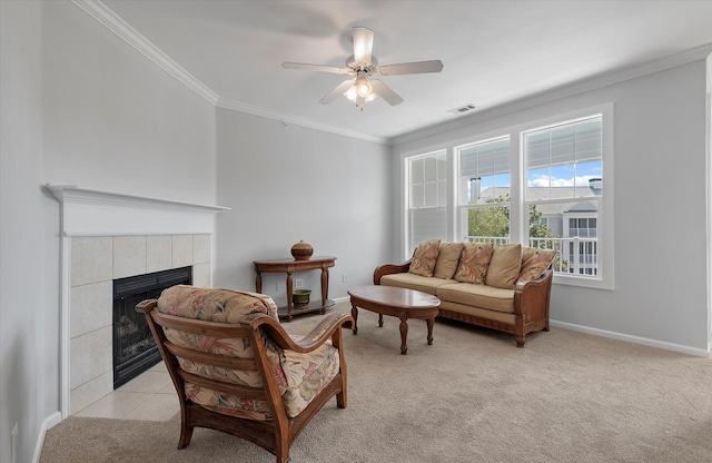 living room featuring light carpet, ceiling fan, ornamental molding, and a fireplace