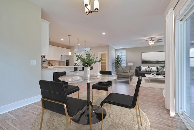 dining space featuring light wood-type flooring and ceiling fan