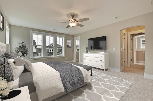 carpeted bedroom featuring ceiling fan and multiple windows