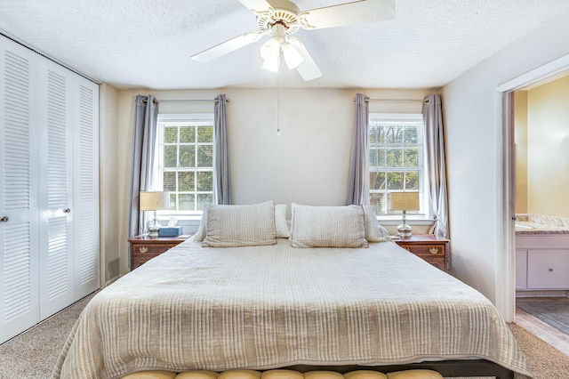 bedroom with carpet, ceiling fan, a textured ceiling, and a closet