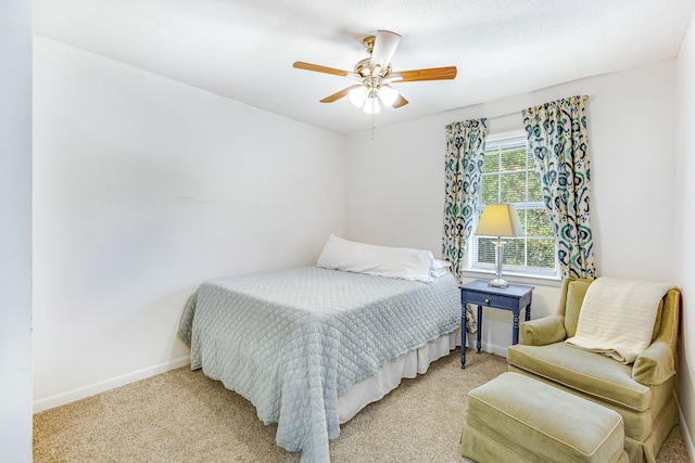 bedroom with ceiling fan and light carpet