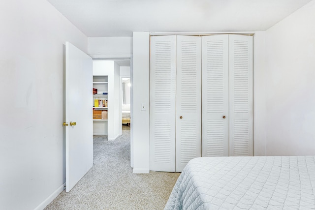 bedroom featuring light carpet and a closet