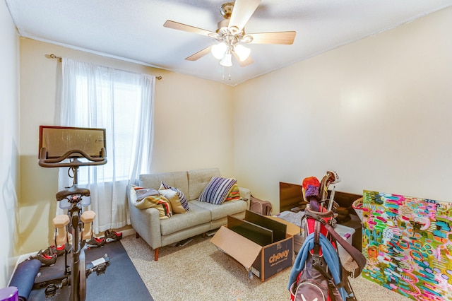 living room featuring carpet flooring, ceiling fan, and a healthy amount of sunlight