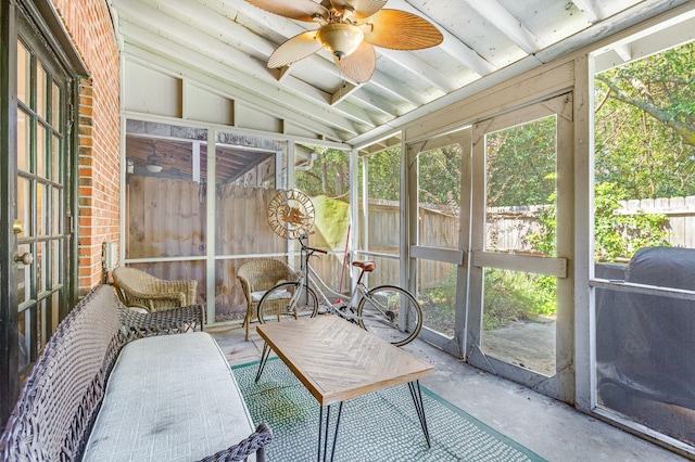 sunroom / solarium with ceiling fan and vaulted ceiling