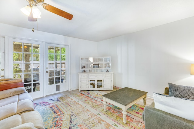 living room with ceiling fan and light hardwood / wood-style flooring