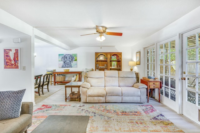 living room featuring light hardwood / wood-style flooring and ceiling fan