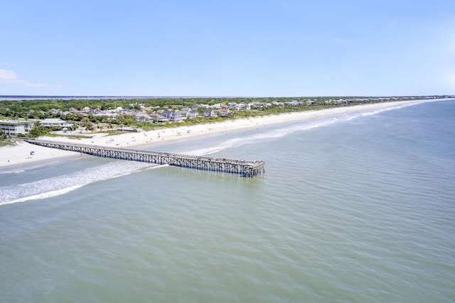 drone / aerial view featuring a water view and a view of the beach