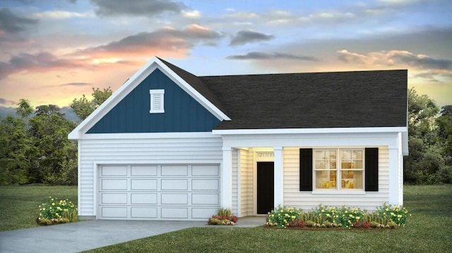 view of front facade featuring a garage and a lawn