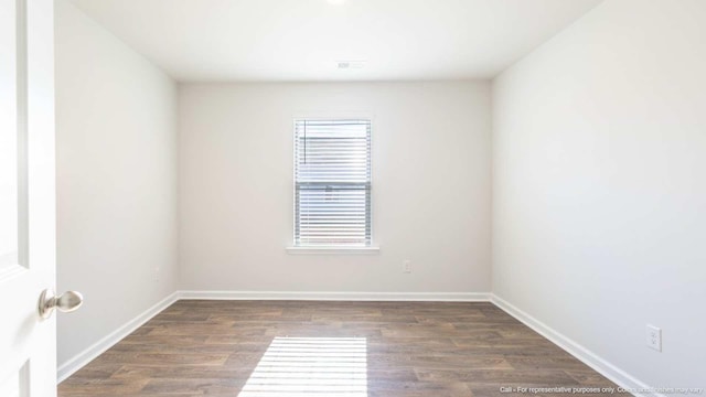 unfurnished room featuring dark hardwood / wood-style floors