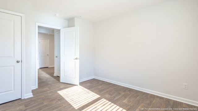 unfurnished bedroom featuring dark wood-type flooring