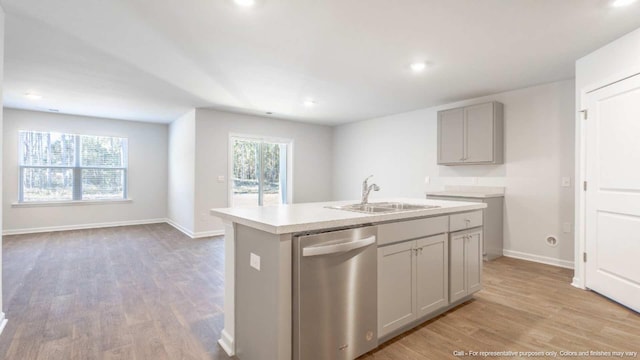 kitchen with dishwasher, a center island with sink, sink, a healthy amount of sunlight, and gray cabinetry