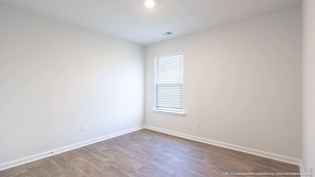 unfurnished room with wood-type flooring