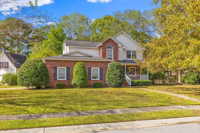 front facade featuring a front lawn and covered porch