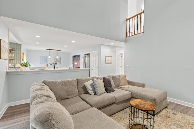 living room with light hardwood / wood-style flooring and sink