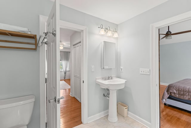 bathroom with ceiling fan, sink, wood-type flooring, and toilet