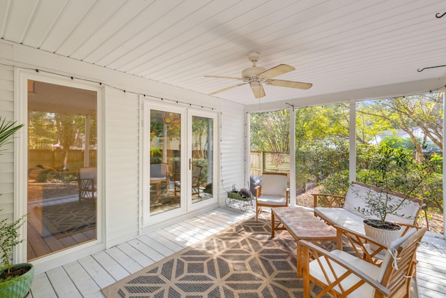 unfurnished sunroom featuring ceiling fan