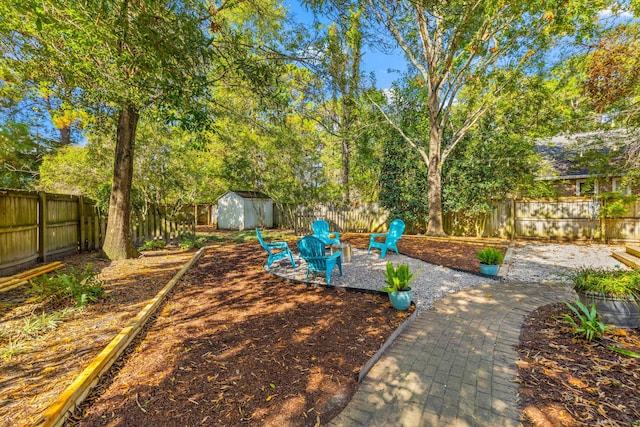 view of yard featuring a shed and an outdoor fire pit