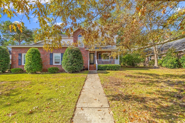 view of front of property featuring covered porch and a front yard