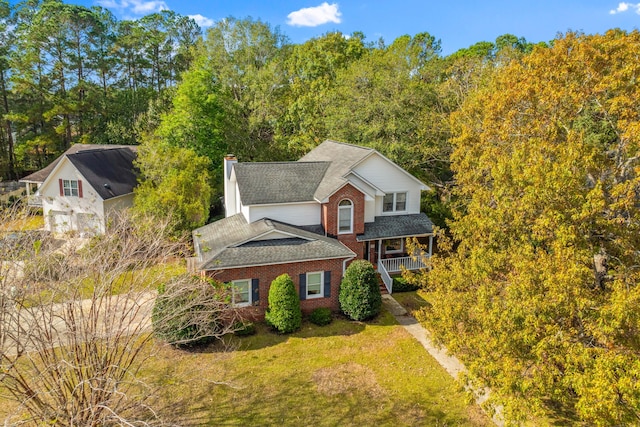 view of front of home with covered porch and a front lawn