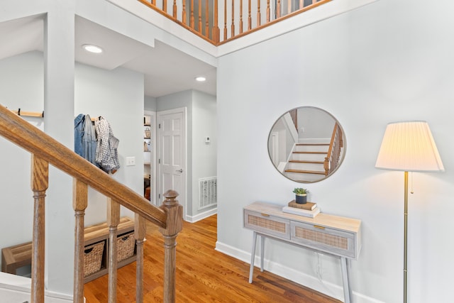 interior space featuring a high ceiling and hardwood / wood-style flooring