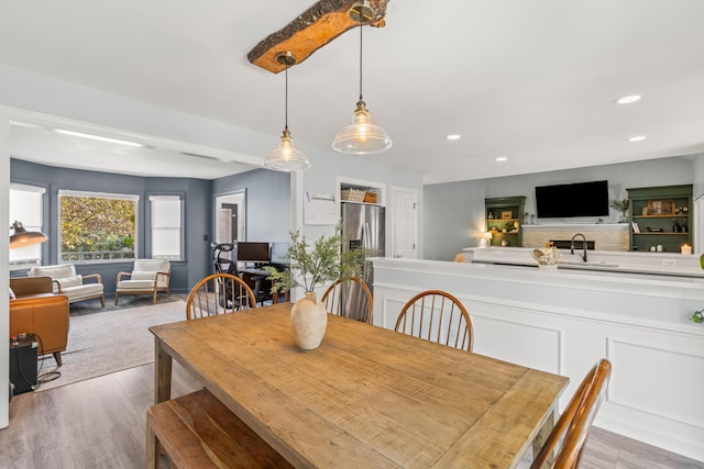 dining space featuring light hardwood / wood-style flooring and sink