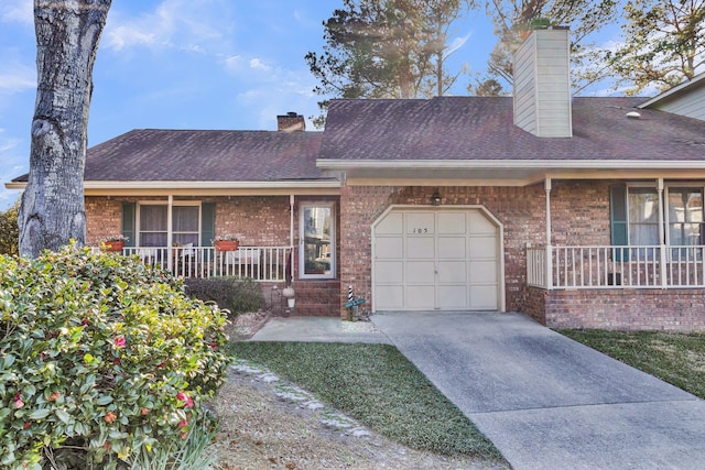 multi unit property with covered porch, brick siding, a chimney, and an attached garage