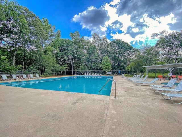 community pool featuring a patio area and fence