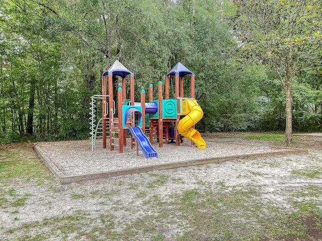 communal playground featuring a forest view