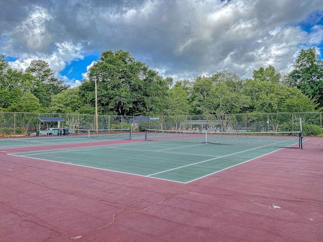 view of sport court featuring fence