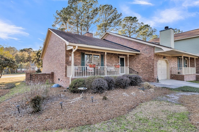 view of front of home with a porch, brick siding, and a garage