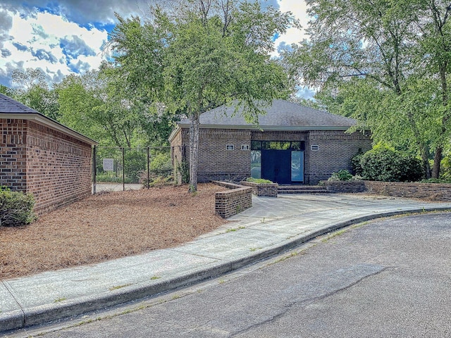 view of front of house with fence and brick siding