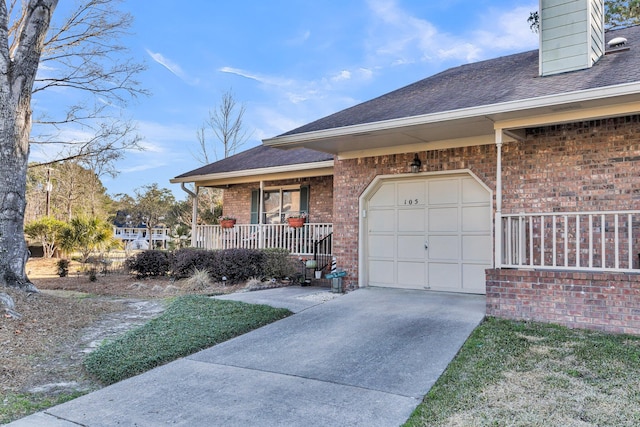 view of front of home with brick siding, roof with shingles, covered porch, concrete driveway, and an attached garage