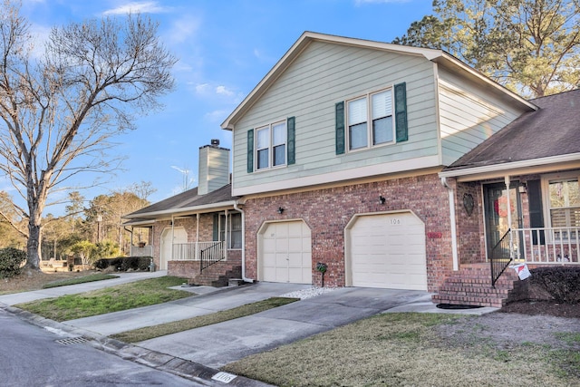 view of front of house featuring a garage, covered porch, and brick siding