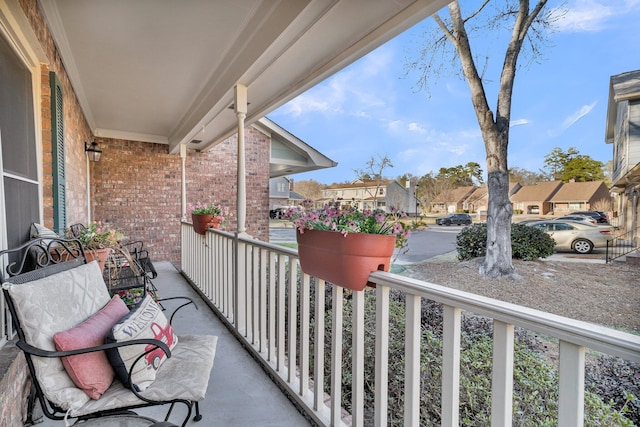 balcony featuring covered porch and a residential view