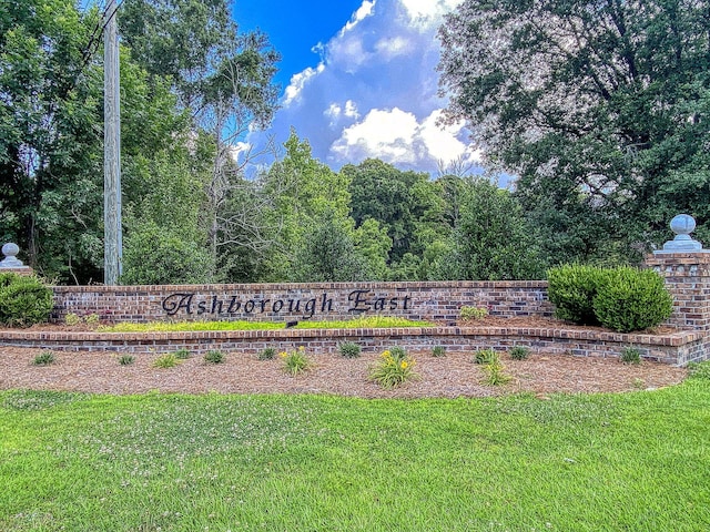 community / neighborhood sign with a yard