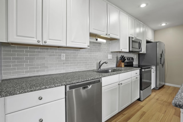 kitchen featuring light hardwood / wood-style floors, sink, white cabinetry, and appliances with stainless steel finishes